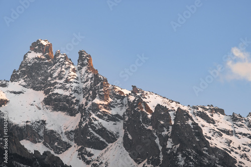 snowy mountain peaks at sunset or sunrise blue sky photo