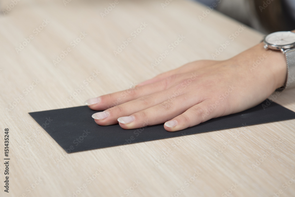 Hand on a black envelope, bribe on the desk Hand on a black envelope, bribe on the desk
