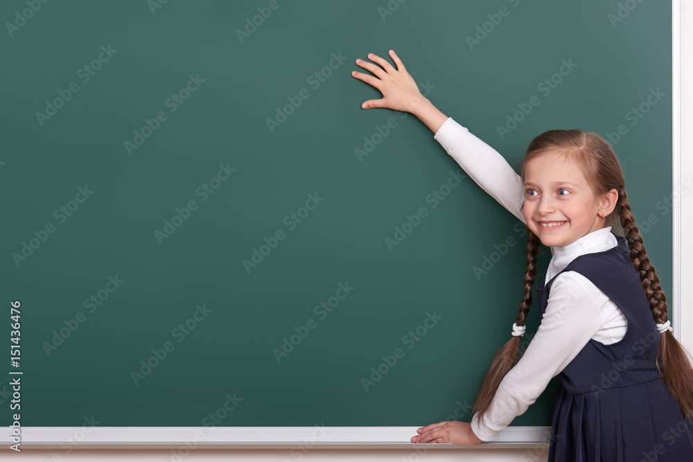 elementary school girl put hands on chalkboard background and show blank space, dressed in classic black suit, group pupil, education concept elementary school girl put hands on chalkboard background and show blank space, dressed in classic black suit, group pupil, education concept