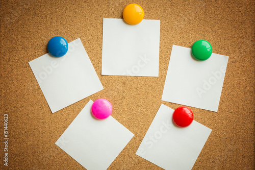 colorful magnet put on white paper on cork board texture or background for note, input text