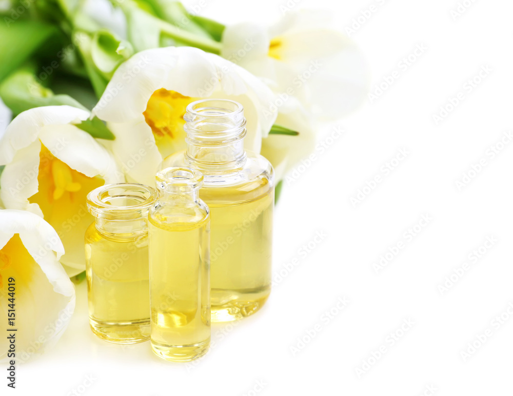 Beautiful composition with perfume bottles and tulip flowers on white background Beautiful composition with perfume bottles and tulip flowers on white background