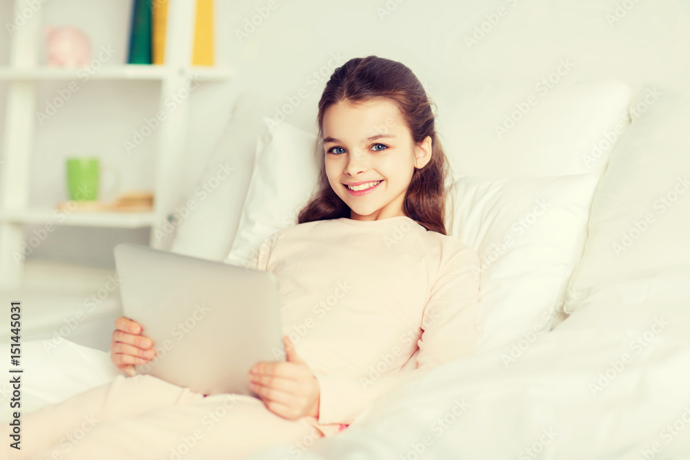 happy girl lying in bed with tablet pc at home happy girl lying in bed with tablet pc at home