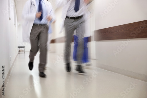 close up of medics or doctors running at hospital