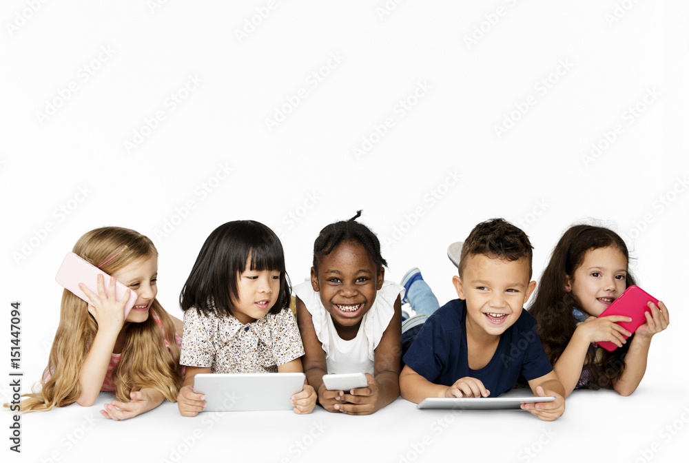 Happiness group of cute and adorable children lay down and using digital devices Happiness group of cute and adorable children lay down and using digital devices