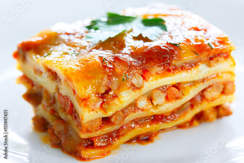 A piece of lasagna on a white plate large