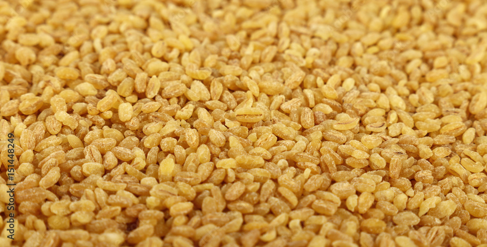 Yellow bulgur big grains close up background Yellow bulgur big grains close up background