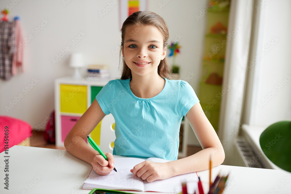 happy girl writing to notebook at home happy girl writing to notebook at home