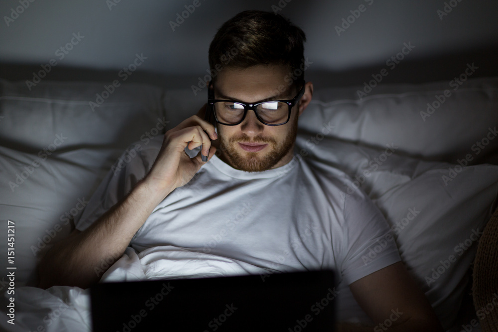 man with laptop calling on smartphone at night man with laptop calling on smartphone at night