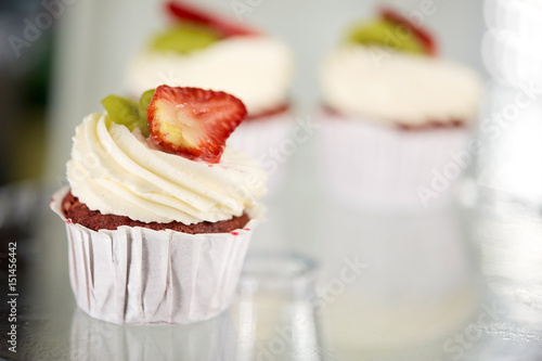 cupcake with cream and strawberry at sweet shop