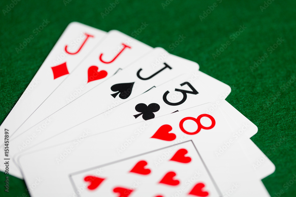 poker hand of playing cards on green casino cloth poker hand of playing cards on green casino cloth