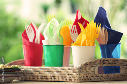 Plastic ware in wicker tray outdoors