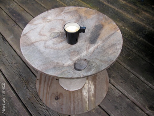 Overhead view of an espresso cup of freshly brewed coffee on an improvised table
