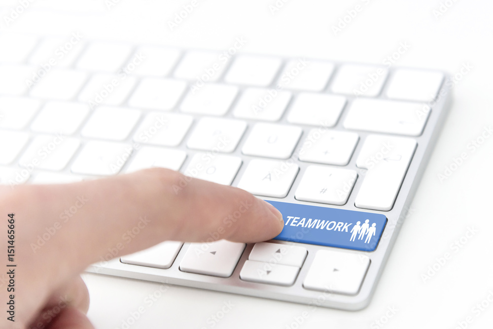 finger pressing a green key labeled TEAMWORK with symbol on a computer keyboard concept finger pressing a green key labeled TEAMWORK with symbol on a computer keyboard concept