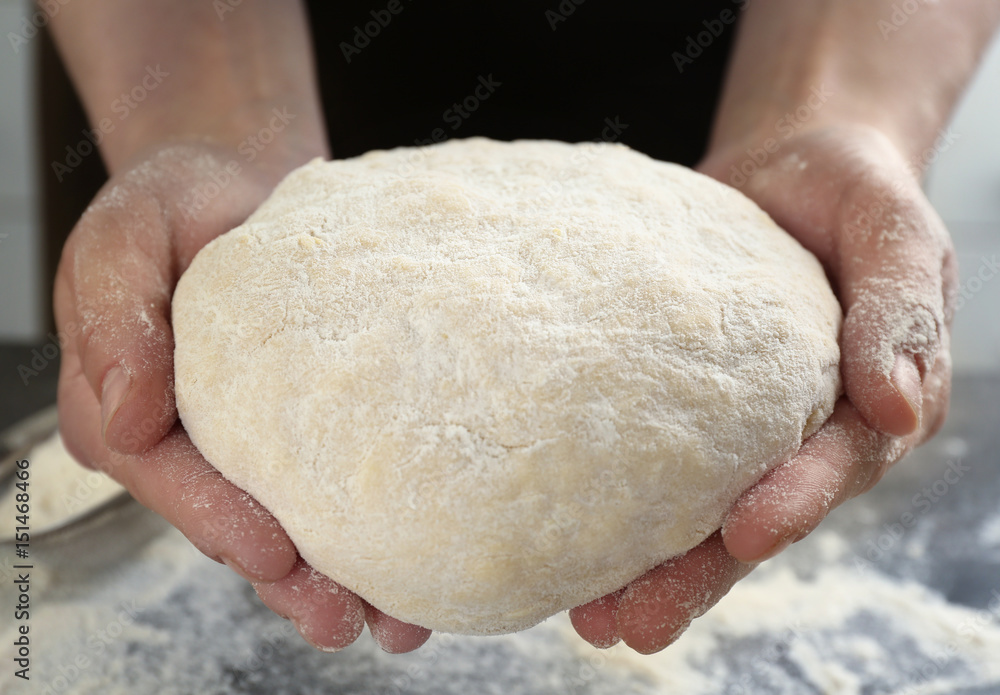 Hands of chef with dough in kitchen, closeup Hands of chef with dough in kitchen, closeup