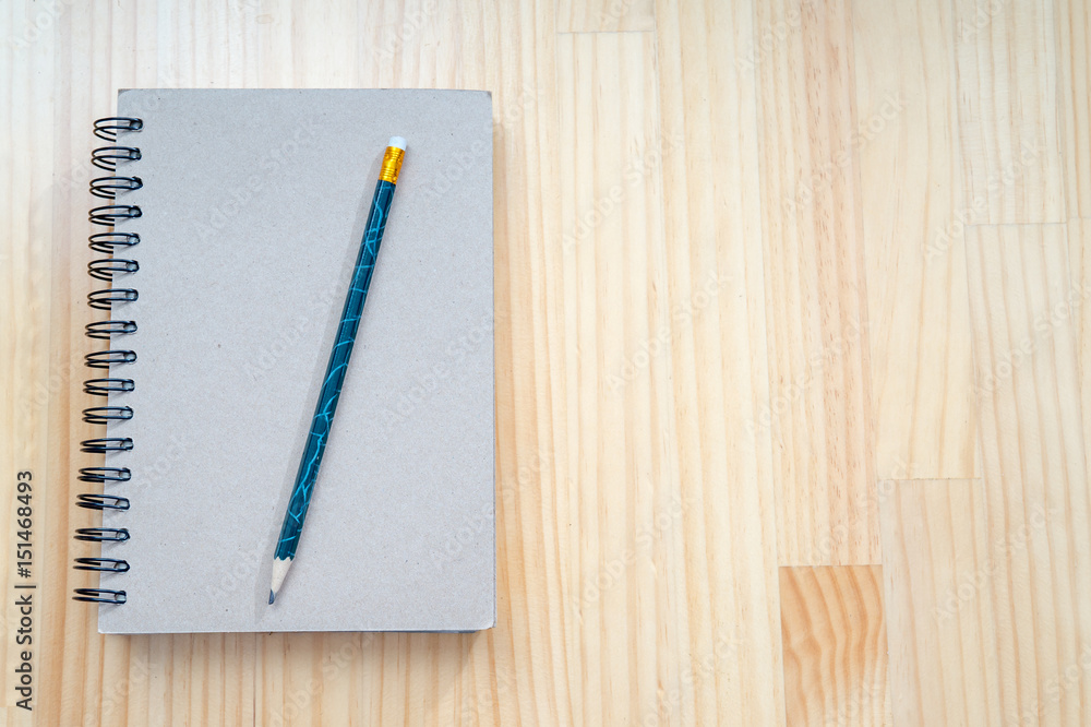 Notebooks and pencils on wooden board Notebooks and pencils on wooden board