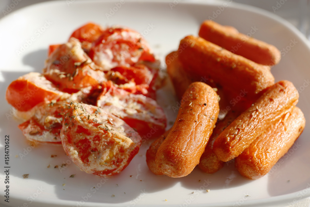 Plate with fried carrot and tomatoes, closeup Plate with fried carrot and tomatoes, closeup