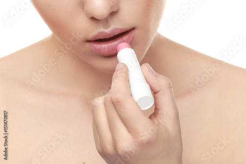 Beautiful young woman with lipstick on white background  closeup