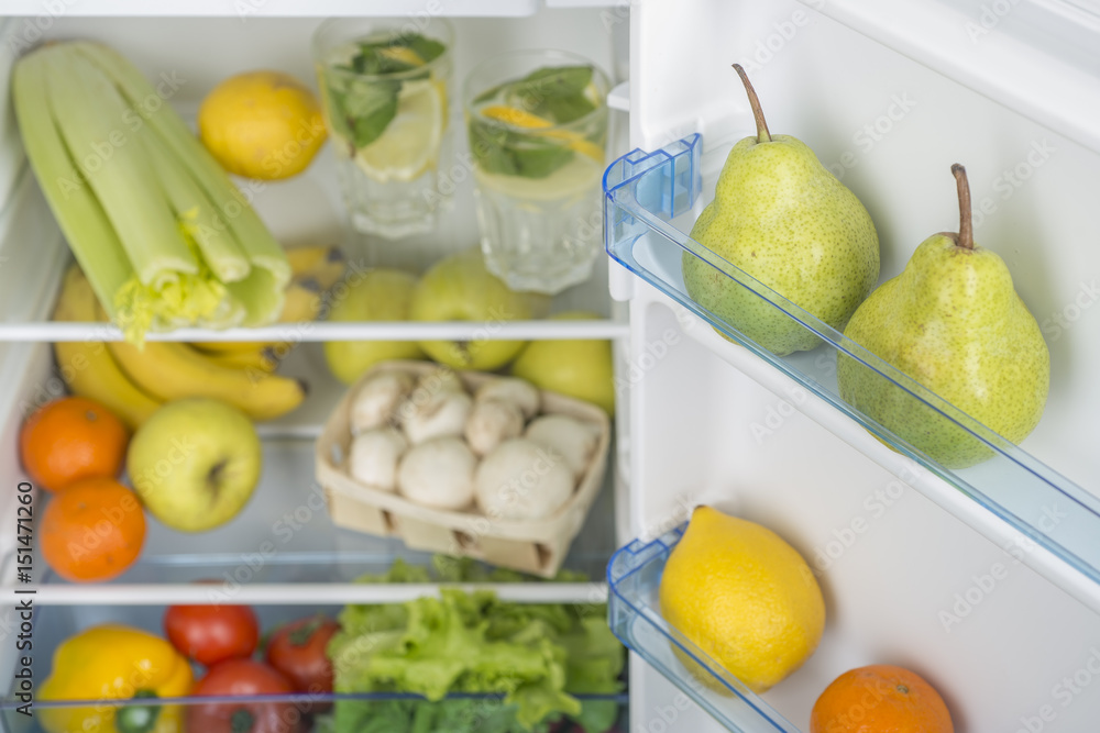 Open fridge full of fresh fruits and vegetables Open fridge full of fresh fruits and vegetables