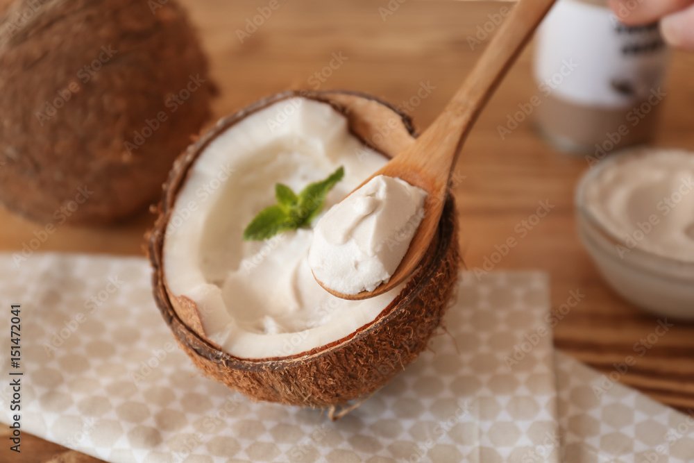 Coconut cream in wooden spoon, closeup Coconut cream in wooden spoon, closeup