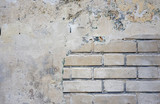 Gray concrete wall and detail of bricks, background or texture