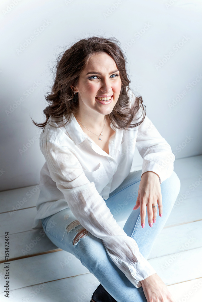 Young woman sitting on the floor Young woman sitting on the floor