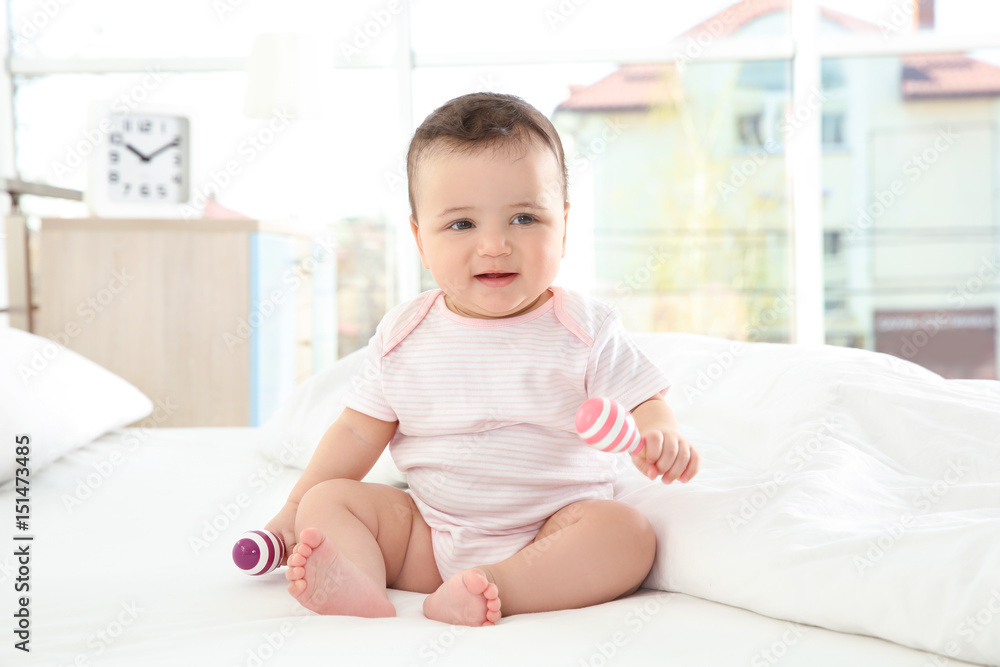 Cute little baby with rattles at home Cute little baby with rattles at home