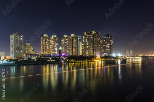 SAIGON  VIETNAM - DEC 27  2016 - Night on the Saigon River  across the river is Saigon Pearl luxury apartment and a big construction site