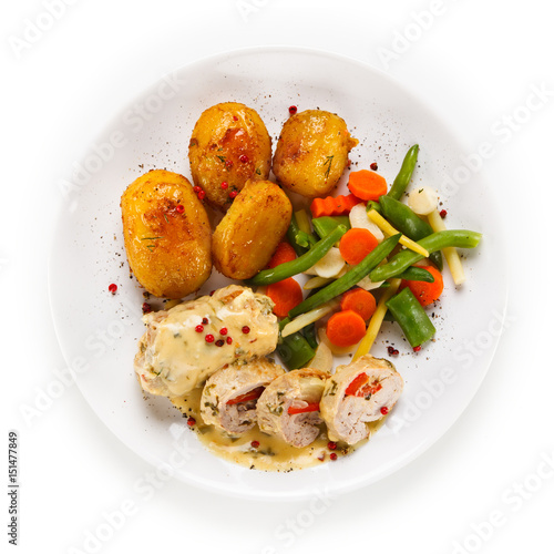 Meatballs with potatoes and vegetables on white background