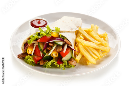 Tortilla wrap with french fries on white background