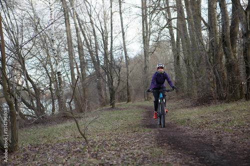 Woman in helmet riding bicycle
