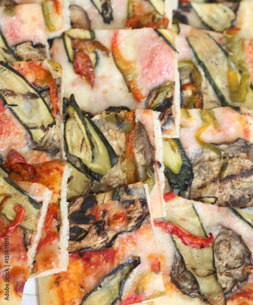 pizza with zucchini eggplant and peppers and many mozzarella che