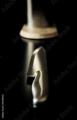 Kitchen knives set against dark brown background