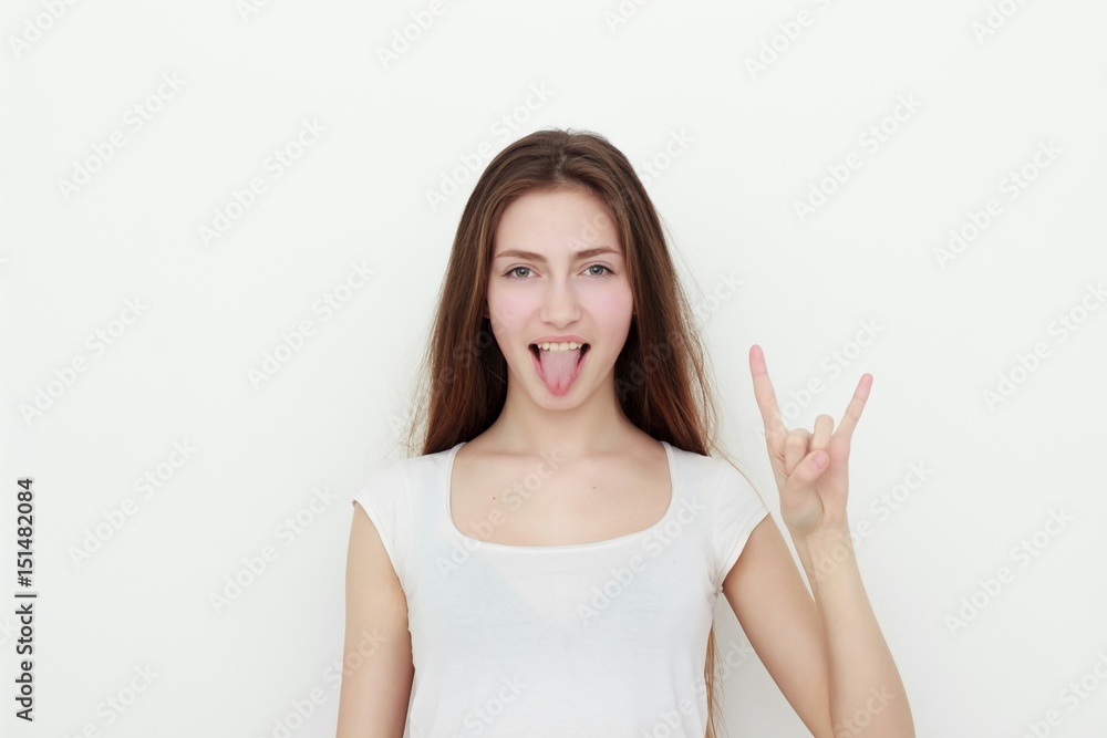 Pretty funny young girl showing tongue and rock gesture Pretty funny young girl showing tongue and rock gesture