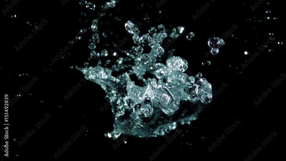 Water bouncing against to the camera on a black background in slow motion Water bouncing against to the camera on a black background in slow motion