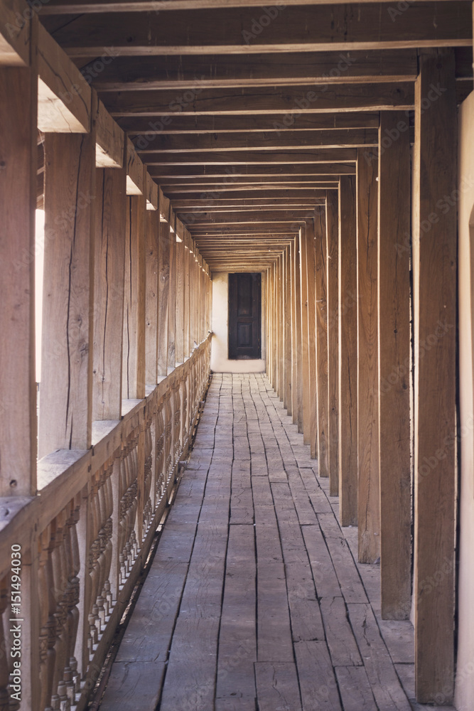 Wooden tunnel with road and door ahead