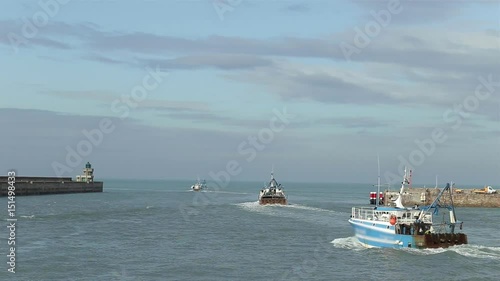 Commercial fishing boats leaving the port. Fisherman boats on the azure waves in Dieppe, Normandy. Real time video in sunny day.