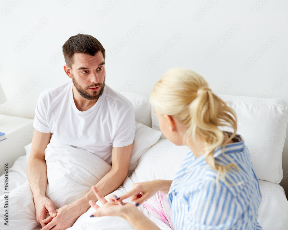 unhappy couple having conflict in bed at home unhappy couple having conflict in bed at home
