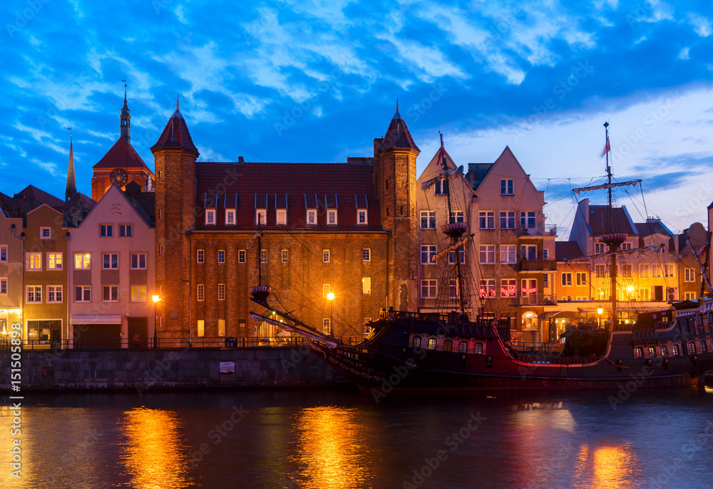 Night in Gdansk - old town waterfront with sailing ship illuminated in night, Gdansk, Poland