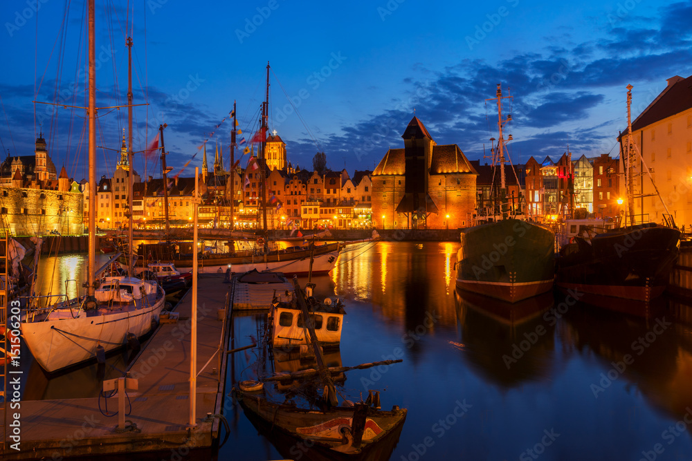 Obraz premium Night in Gdansk - old town waterfront with ships harbor illuminated in night, Gdansk, Poland