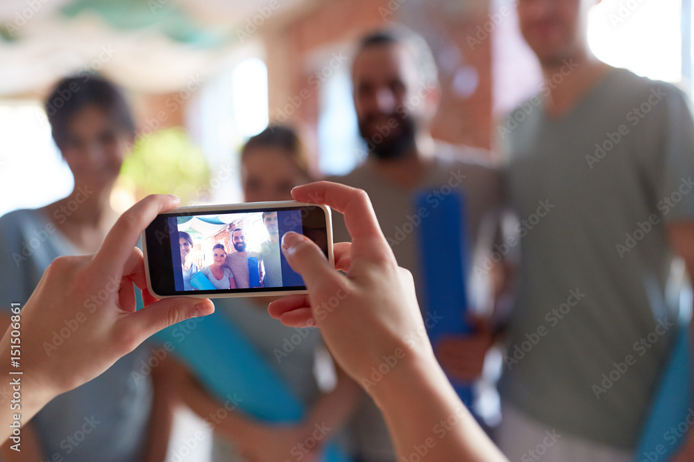 photo of people at yoga studio on smartphone