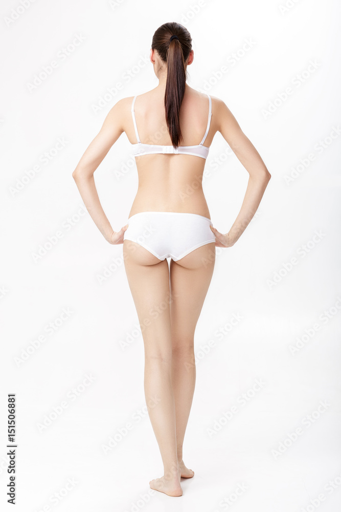 back view of beautiful young brunette woman with perfect sporty body in white  lingerie on white background. Stock Photo | Adobe Stock
