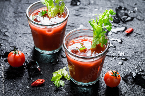 Cold bloody mary cocktail with chili peppers photo
