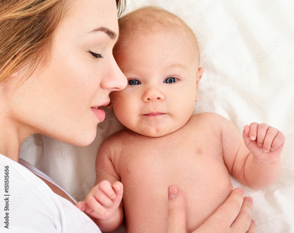 Mother and baby playing and smiling. Happy family. Mother and baby playing and smiling. Happy family.