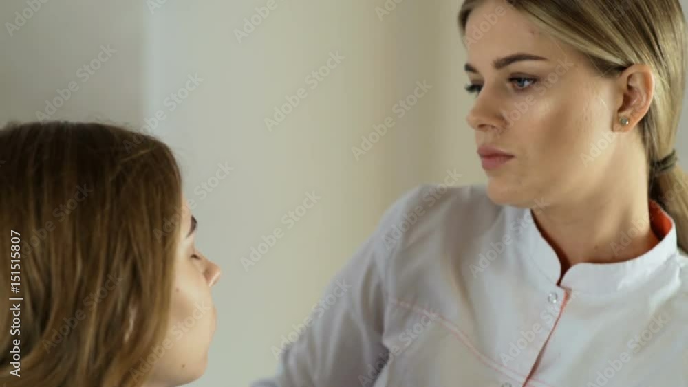 Cosmetology. A girl at a reception in a beauty salon. Eyebrow correction. Cosmetology. A girl at a reception in a beauty salon. Eyebrow correction.