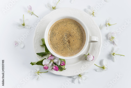 coffee concept/white cup of coffee and apple flowers on white background top view