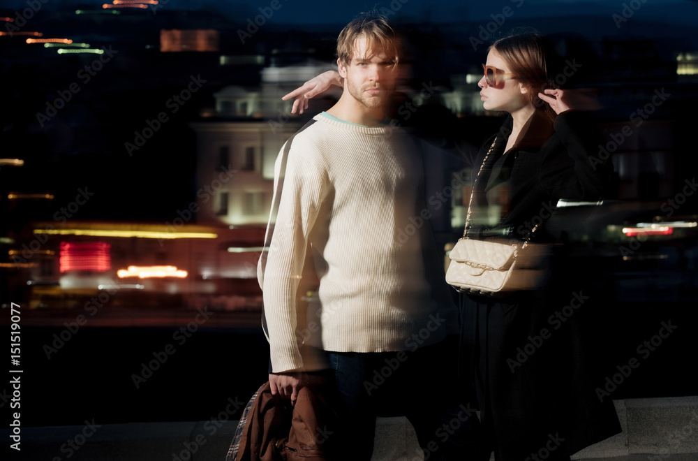 Φωτογραφία couple of friends, man, girl on blurred night city illumination