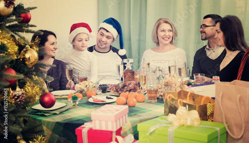 Multigenerational happy smiling family sitting at festive table