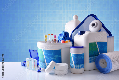 Chemical cleaning products for pool with blue mosaic background overview photo