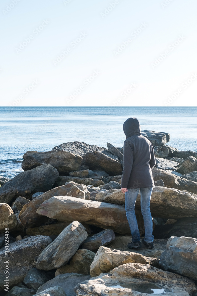 Woman walking on big stone at background