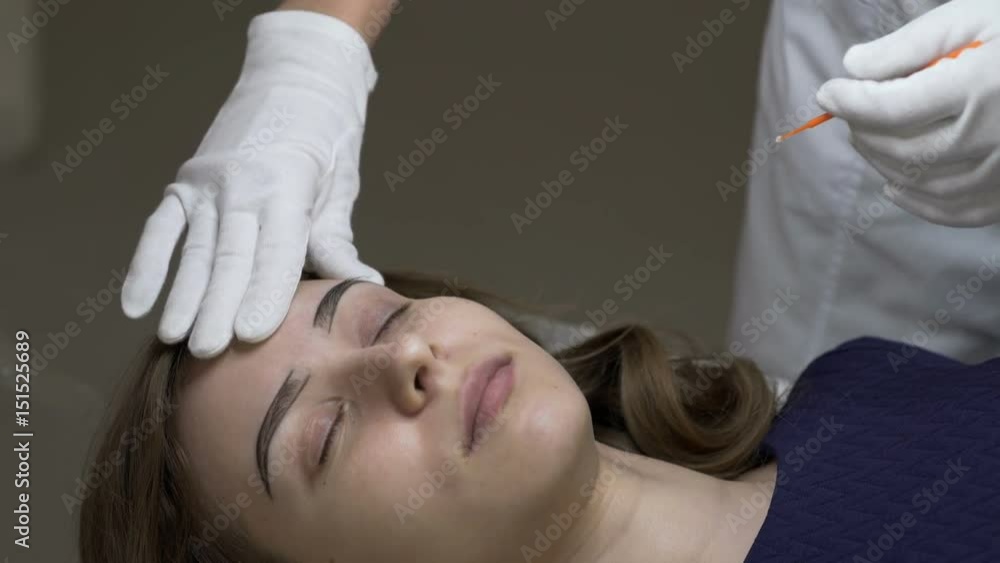 Cosmetology. A girl at a reception in a beauty salon. Eyebrow correction. Cosmetology. A girl at a reception in a beauty salon. Eyebrow correction.